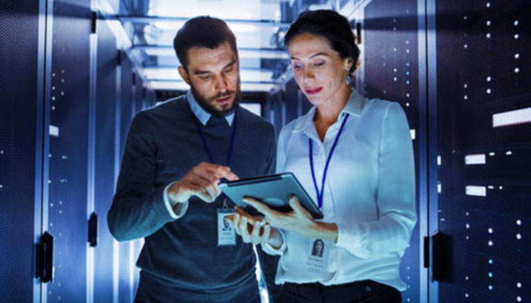 Two people working in a datacentre 