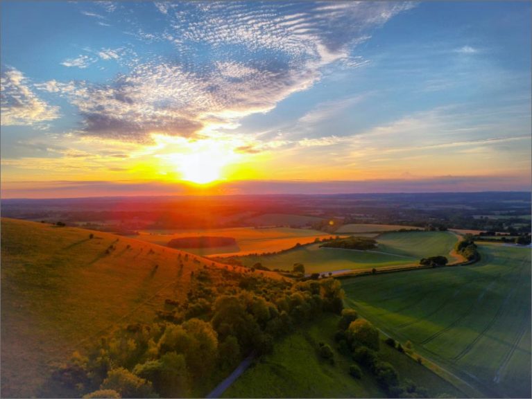 Image of sun setting over fields