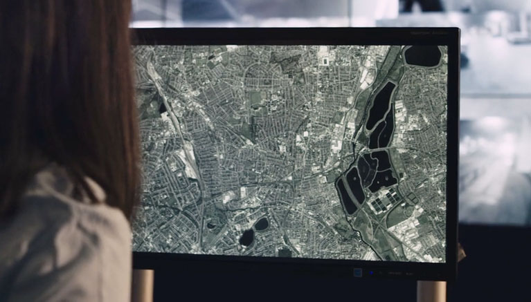 Imge of woman looking at map on screen