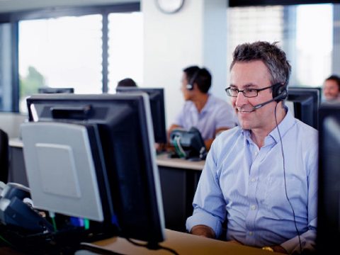 Man working in a office using a headset