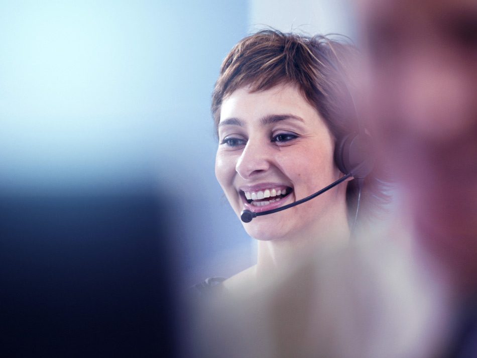 Woman working in an office using a headset