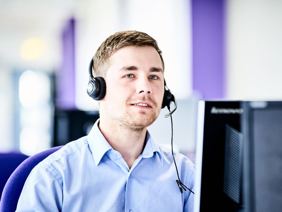 Man working in office using headset